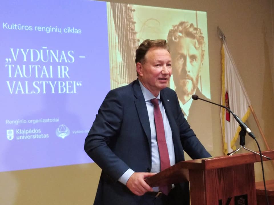 Paveikslėlis, kuriame yra žinutė, asmuo, vyras, kostiumas Automatiškai sugeneruotas aprašymas