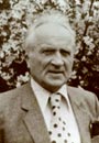 A person wearing a suit and tie Description automatically generated with medium confidence